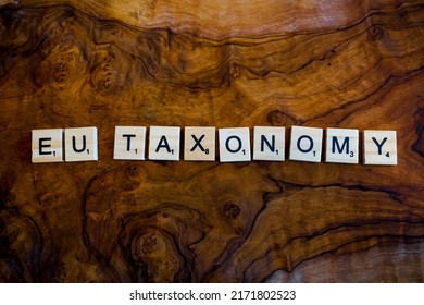 Stockholm, Sweden - 26 June 2022: Eu Taxonomy Written In Sustainable Wooden Tiles On Vintage Wood Background As A Concept