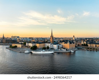 Stockholm, Sweden - 29 July 2024: Aerial view of Gamla Stan, old town in Stockholm in sunset with Riddarholmskyrkan church in foreground and a colorful clear sky background - Powered by Shutterstock