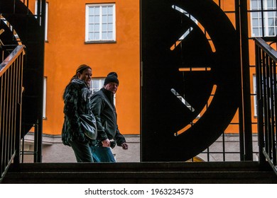 Stockholm, Sweden April 25, 2021 Pedestrians Walk By An Open Iron Gate In A  Public Stairway Between Atlasgatan And Sankt Eriksgatan