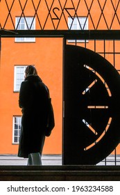 Stockholm, Sweden April 25, 2021 A Woman Pedestrian Walks By An Open Iron Gate In A  Public Stairway Between Atlasgatan And Sankt Eriksgatan