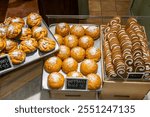 Stockholm, Sweden An assortment of freshly baked saffron buns and pepparkakor in a bakery window.