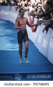 STOCKHOLM, SWEDEN - AUG 26, 2017: Winner Flora Duffy (BER) Running Into The Finish Area With The Crowd Cheering At The Womens ITU Triathlon Series. Female Olympic Distance.