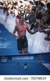 STOCKHOLM, SWEDEN - AUG 26, 2017: Winner Flora Duffy (BER) Running Into The Finish Area With The Crowd Cheering At The Womens ITU Triathlon Series. Female Olympic Distance.