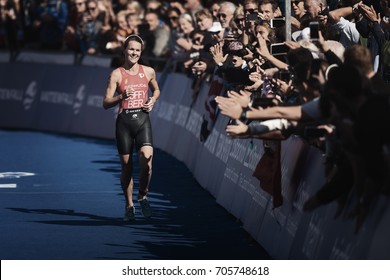 STOCKHOLM, SWEDEN - AUG 26, 2017: Winner Flora Duffy (BER) Running Into The Finish Area With The Crowd Cheering At The Womens ITU Triathlon Series. Female Olympic Distance.