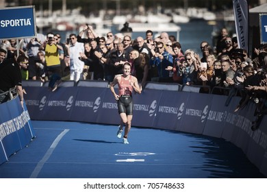 STOCKHOLM, SWEDEN - AUG 26, 2017: Winner Flora Duffy (BER) Running Into The Finish Area With The Crowd Cheering At The Womens ITU Triathlon Series. Female Olympic Distance.