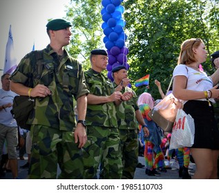 STOCKHOLM, SWEDEN - AUGUST 1, 2015: The Swedish Military attending the annual Stockholm Pride parade 2015 in their standard green camouflage uniforms.