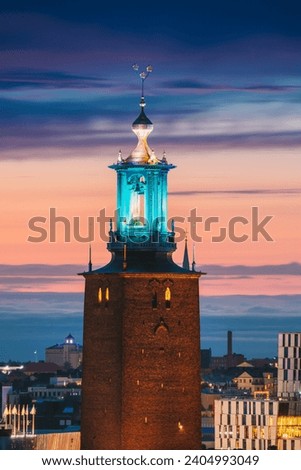 Stockholm, Sweden. Close View Of Famous Tower Of Stockholm City Hall. Popular Destination Scenic In Sunset Twilight Dusk Lights. Evening Lighting.