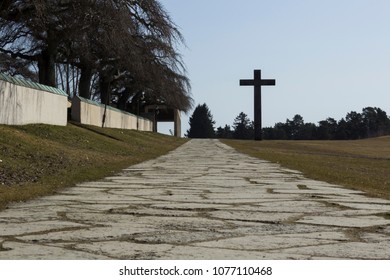 Stockholm / Sweden - February 14 2018: Road Leading Up To The Massive Granite Cross, At The UNESCO World Heritage The Woodland Cemetery - Skogskyrkogården.