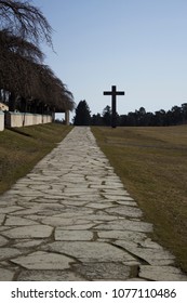 Stockholm / Sweden - February 14 2018: Road Leading Up To The Massive Granite Cross, At The UNESCO World Heritage The Woodland Cemetery - Skogskyrkogården.