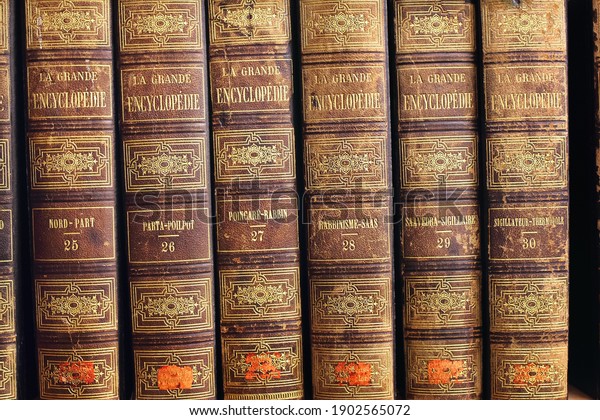 STOCKHOLM, SWEDEN - JAN 09, 2020. A row of\
vintage books, several volumes of large encyclopedia (la grande\
encyclopadie), french language, brown binding with gold lettering\
in Stockholm Public\
Library
