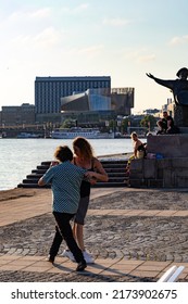 Stockholm, Sweden July 1, 2022 Dancers Practive Tango Dancing On Riddarholmen Near The Water Under A Landmark Statue Of Evert Taube, A National Troubadour.