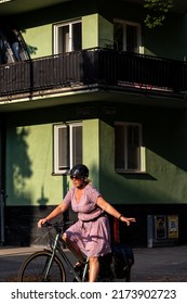 Stockholm, Sweden July 1, 2022 A Woman On A Bicycle Signaling A Left Turn.