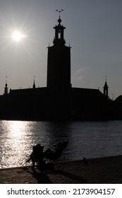 Stockholm, Sweden July 1, 2022 A Couple Is Relaxing In Beach Chairs At Sunset Overlooking Riddarfjarden And The City Hall.