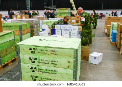 Stockholm, Sweden March 27, 2020 The Stockholm Fair Grounds Are Being Turned Into A Temporary External Hospital To Handle Covid 19 Cases. Here A Warehouse Full Of Medical Supplies Getting Unpacked By 