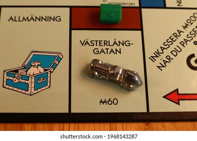 Stockholm, Sweden. May 02, 2021. Monopoly Board Game. Close Up Over The Brown Street Called Västerlånggatan. Written In Swedish. The Metal Car Token And One Green House. Classical Boardgame.