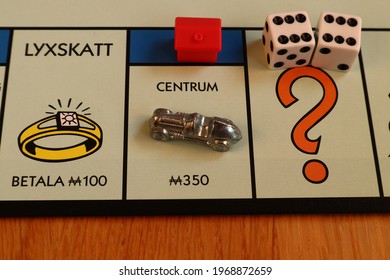 Stockholm, Sweden. May 02, 2021. Monopoly Board Game. Close Up Over The Blue Street Centum And Luxuary Tax. Written In Swedish. The Metal Car Token, Double Dice And A Red Hotel. Classical Boardgame.