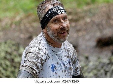 STOCKHOLM, SWEDEN - MAY 14, 2016: Senior Smiling Man Covered With Mud In The Obstacle Race Tough Viking Event In Sweden, April 14, 2016