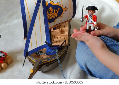 Stockholm, Sweden. September 04, 2021. Child Playing With Playmobil Pirates. British Red Coat Soldier. No Face, Only Hands Visible. White Background.  