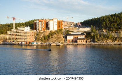 Stockholm Sweden - September 26 2021: Stockholm Archipelago. Building An Apartment House On Granite Cliffs. Green Forest Around. Boating On Baltic Sea Waters In Front. Blue Clear Sky.