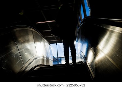 Stockholm, Sweden A Woman Goes Up An Escalator In A Tunnelbana Station.