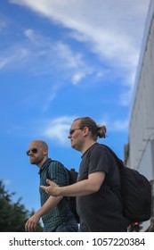 Stockholm/Sweden - 25.07.2016: Long Haired And Bald Man Walking Together In A Bright Day.