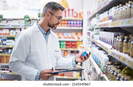 Stocking The Shelves Is Top Priority. Shot Of A Mature Pharmacist Doing Inventory In A Pharmacy.