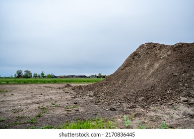 stockpiled topsoil at a residential development construction site.