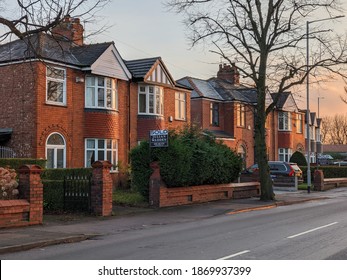 Stockport, Greater Manchester, UK. December 7, 2020. 1920s 1930s style semi-detached houses on Broadstone Road, Heaton Chapel with bay window and apex roof. Sold sign.