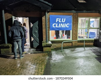 Stockport, Greater Manchester, UK. December 8, 2020. Evening Flu Vaccination Clinic At General Practitioner Surgery With Queue Of People.