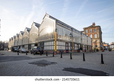Stockport, Manchester, UK - April 10, 2022:  The Victorian Market Hall and cobbled Market Place of Stockport in Greater Manchester.
