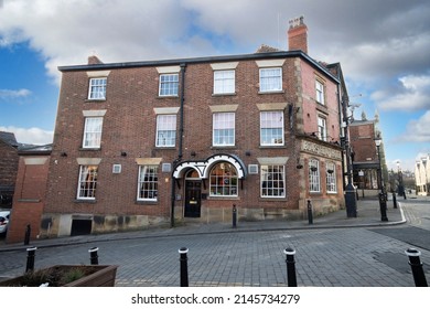 Stockport, Manchester, UK - April 10, 2022: Commercial buildings looking onto the cobbled Market Place, Stockport