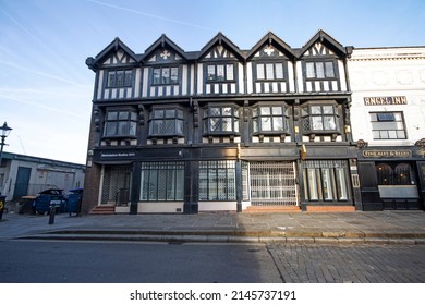 Stockport, Manchester, UK - April 10, 2022: Black and white Tudor building fronting onto the cobbled Market Place, Stockport