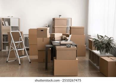 Stockroom filled with multiple various sizes cardboard boxes parcels stacked and arranged around cozy spacious room, no people. Inventory management, electronic commerce, logistics, packing workspace - Powered by Shutterstock