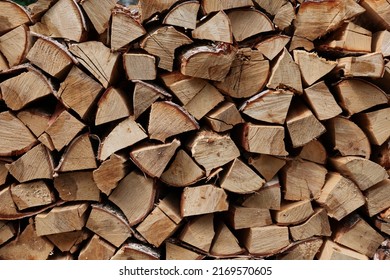 Stocks of wooden firewood close-up. Stacked firewood close up. Village lifestyle.