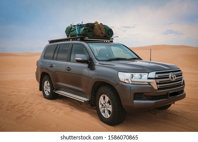 Stockton Beach, New South Wales  Australia - October 2 2017: Toyota Landcruiser with luggage on roof rack parked on Stockton beach. Beach four wheel driving. 