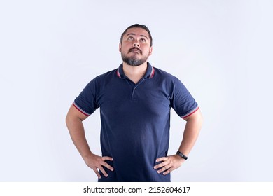 A stocky man looking up, thinking and visualizing his plans. A mixed race male in his 30s. Isolated on a white background.