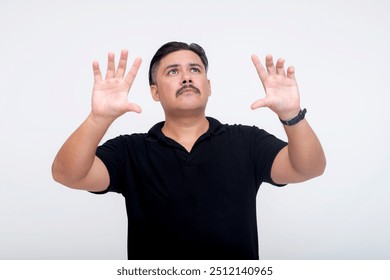 A stocky middle-aged man of mixed race interacting with a virtual screen or menu using his hands. For further editing purpose. Set against a white background. - Powered by Shutterstock