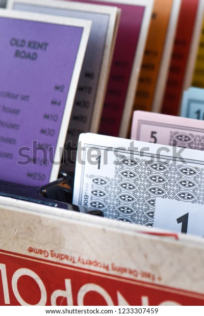 Stoke on\
Trent, Staffordshire - 18th November 2018 - Monopoly board\
properties and money stacked neatly in the banking tray during a\
game on the 80th anniversary edition board\
game