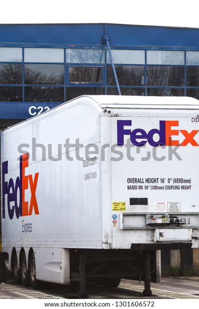 Stoke on Trent, Staffordshire - 1st February\
2019 - Fed Ex lorries ready having maintenance and being loaded\
with parcels to be delivered across the country and world, Heavy\
goods vehicles, logistics
