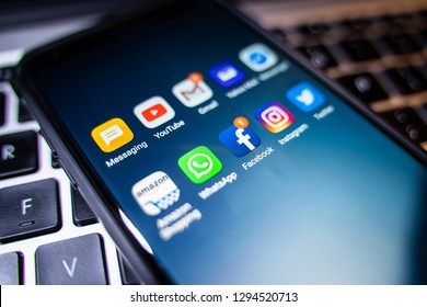 Stoke on Trent, Staffordshire - 25th January 2019 - An image of a smart phone with social media applications on it, resting on a keyboard. Facebook, Instagram, WhatsApp, Twitter, Youtube, Amazon