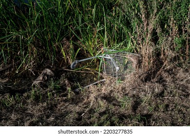 Stolen And Abandoned Shopping Trolley Seen Discarded By Youths At The Side Of A Riverbank In The UK.