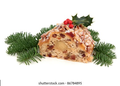 Stollen Christmas Cake With Holly Berry And Blue Pine Fir Leaf Sprigs Isolated Over White Background.