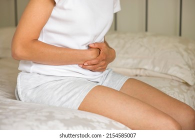 Stomach Pain, Asian Indian Woman Holding Her Stomach In Pain