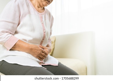 Stomach Pain Of Old Woman At Home, Healthcare Problem Of Senior Concept