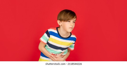 Stomach Pain. Teen Boy With Stomachache. Child Having Terrible Pain In Stomach. Diarrhea Or Gastroenteritis Health Problem. Child Has Stomachache With Food Poisoning. Child Holding Hands On Belly.