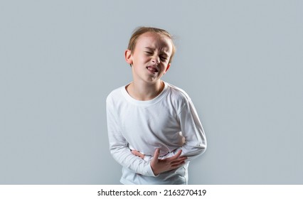 Stomach Pain. Teen Boy With Stomachache. Child Having Terrible Pain In Stomach. Diarrhea Or Gastroenteritis Health Problem. Child Has Stomachache With Food Poisoning. Child Holding Hands On Belly.