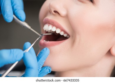 Stomatologist taking care of patient oral cavity - Shutterstock ID 667433335
