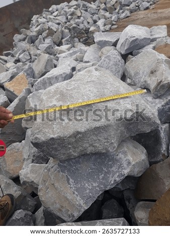 Stone aggregate measurement at the quarry using tape before loading to the barge or scow