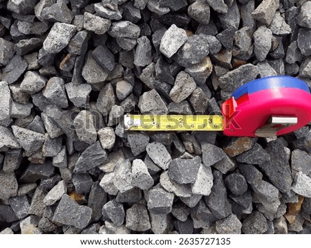 Stone aggregate measurement at the quarry using tape before loading to the barge or scow