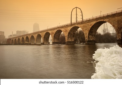 Stone Arch Bridge Over the Mississippi River in Winter - Downtown Minneapolis. 